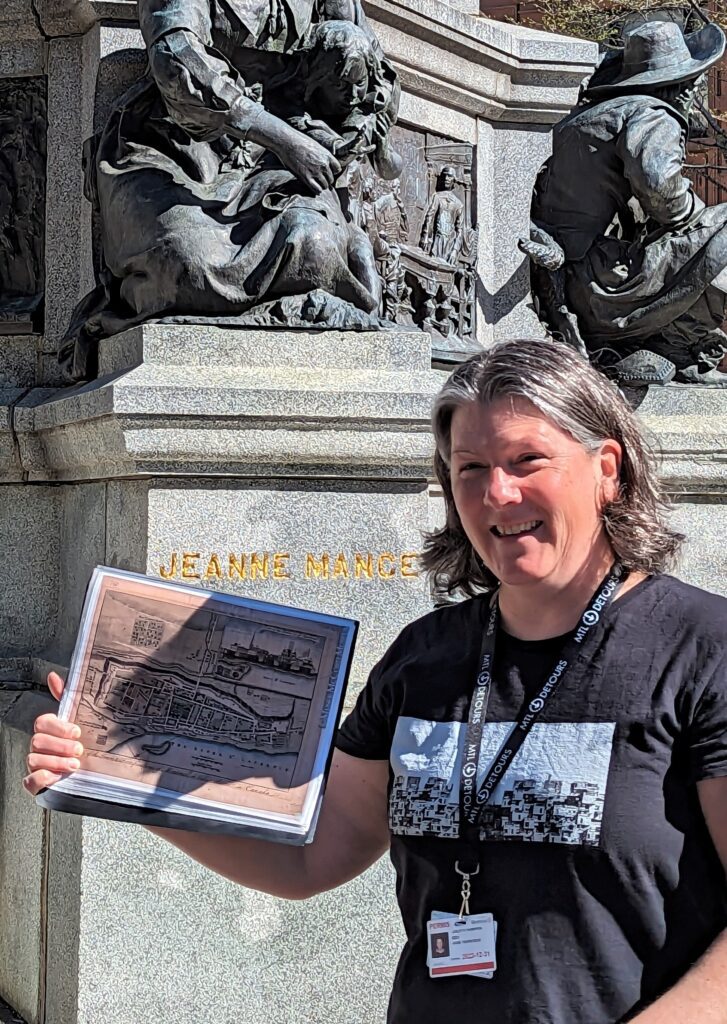 A certified Montreal tour guide holding a historic city map at in Old Montreal