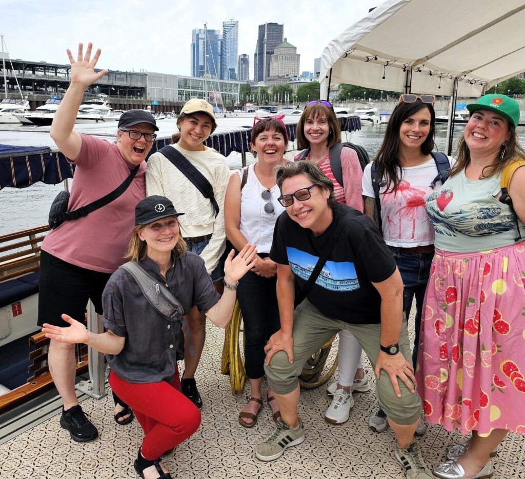 MTL Detours team members smiling together on a boat in Montréal’s Old Port.